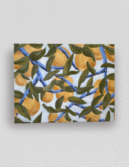 Painting with oranges and green leaves on a pale blue sky background.