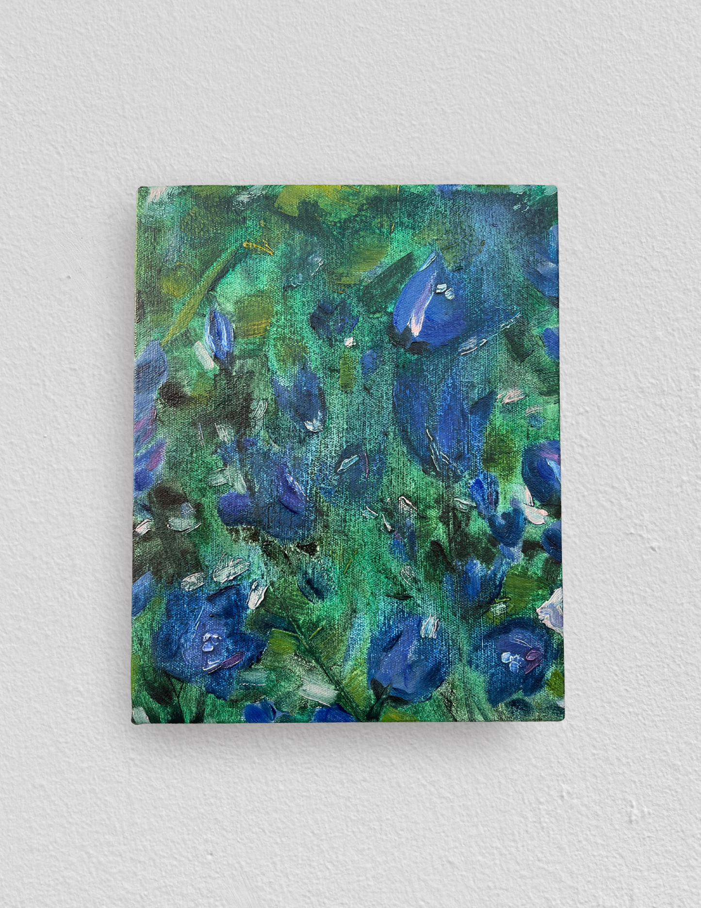 Small rectangular oil painting of semi-abstract blue harebells against a dreamy swirled green foliage background. 